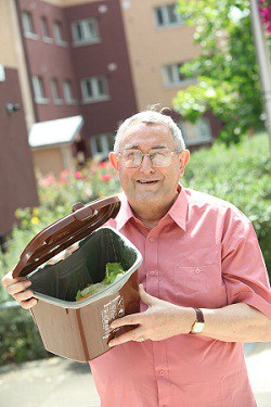 Southwark resident John Gorusch with one of the kitchen caddies which residents across the borough are now using to recycle food waste